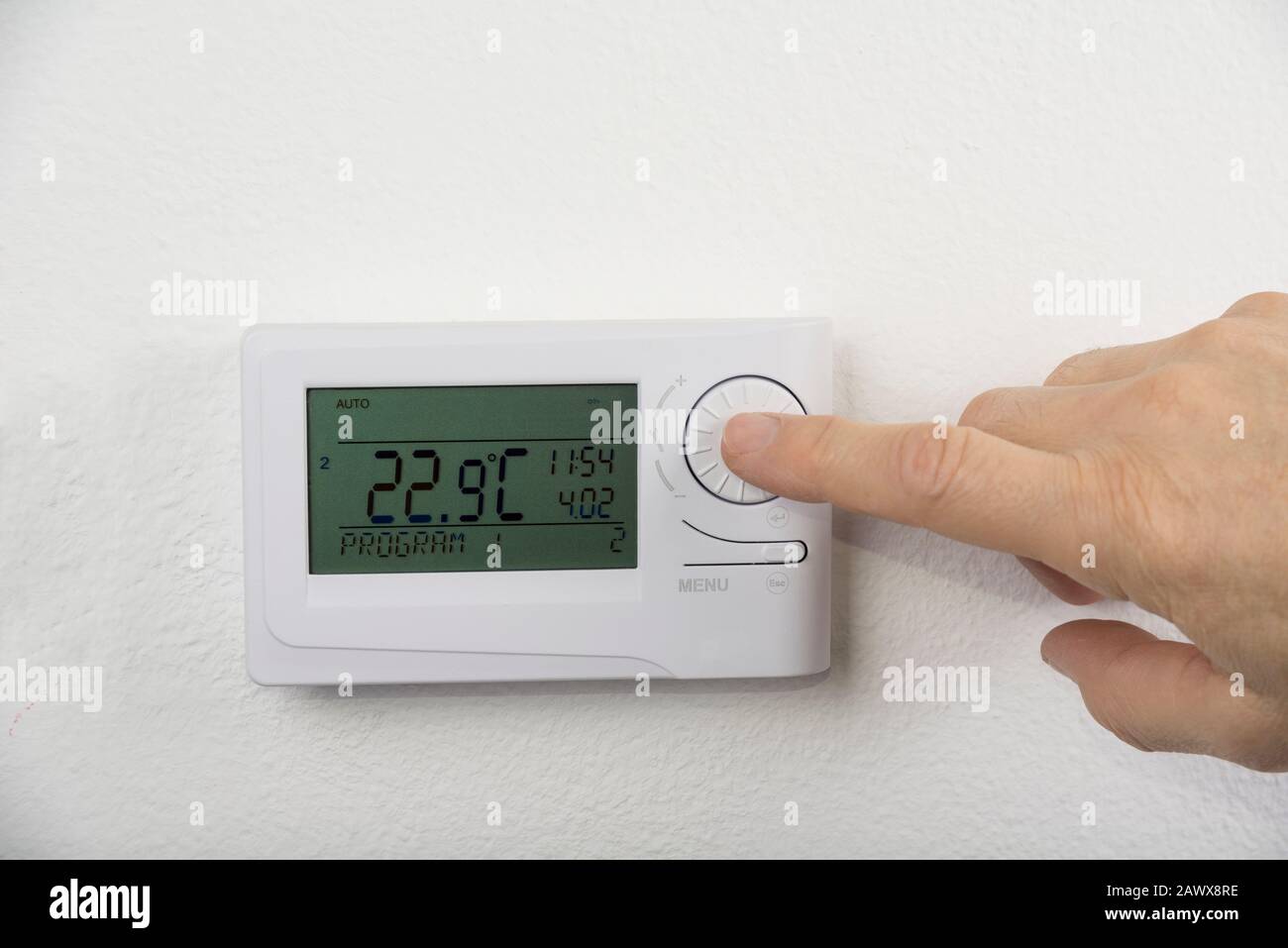 Modern heat thermostat on a white background Stock Photo - Alamy