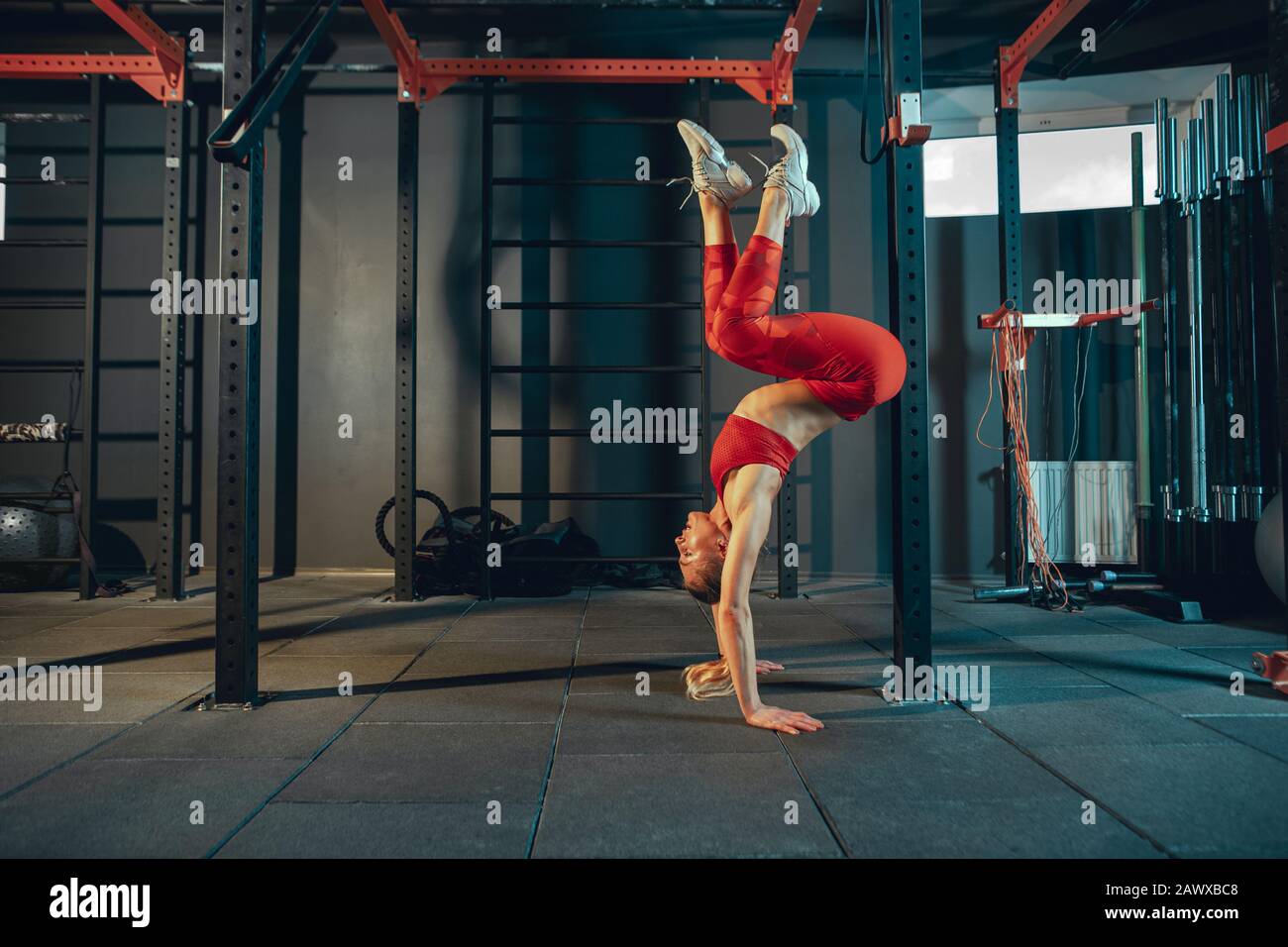Balanced. Young muscular caucasian woman practicing in gym. Athletic
