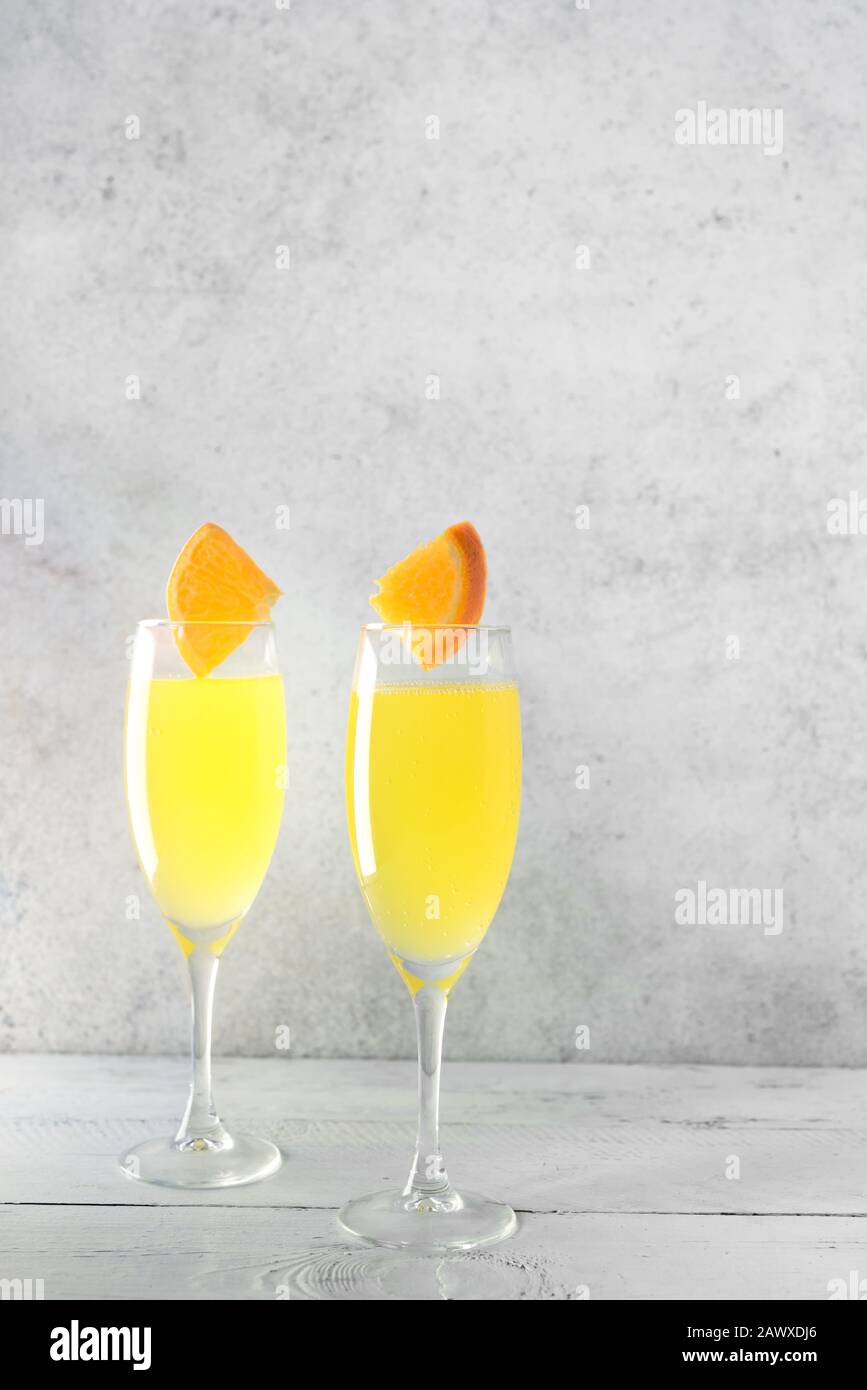 Mimosa cocktail with Champagne and Orange juice in flute glasses, copy