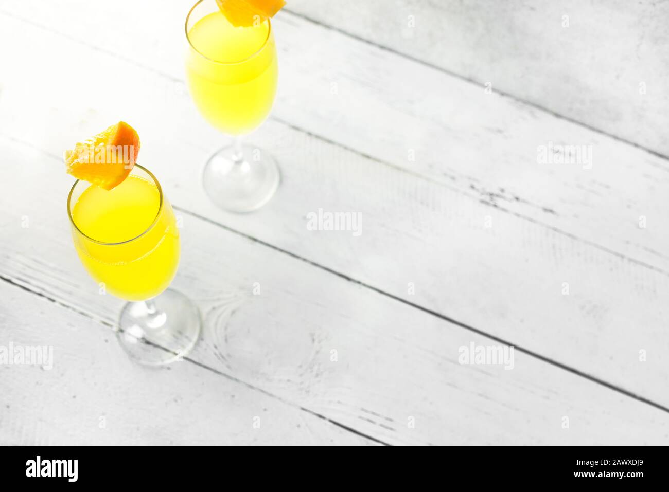 Mimosa cocktail with Champagne and Orange juice in flute glasses, copy ...