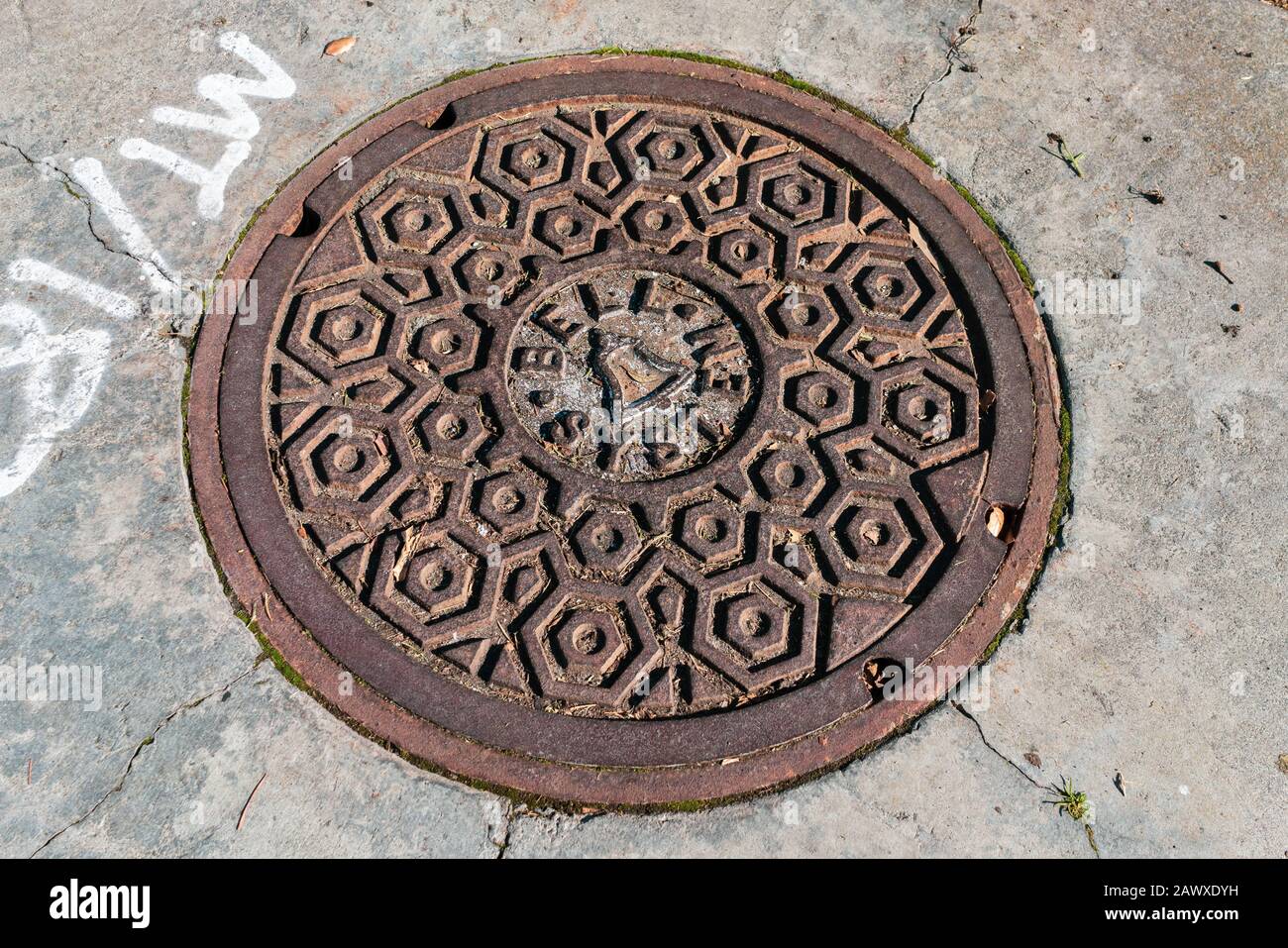 Jan 24, 2020 Sunnyvale - Close up of historic rusted Bell System manhole cover; the old landlines are owned by AT&T in California Stock Photo