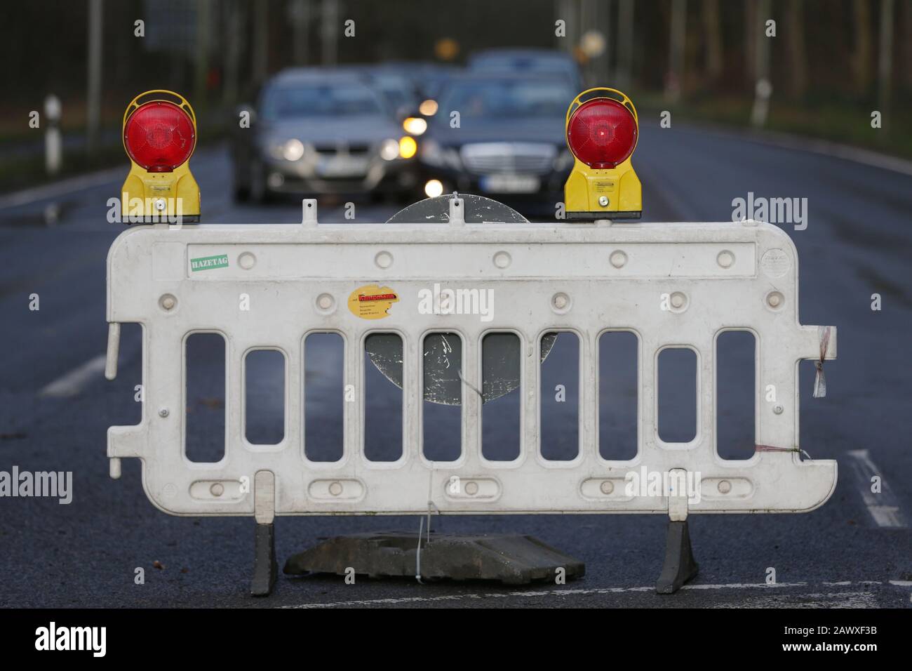 Duesseldorf, Germany. 10th Feb, 2020. Cars stand behind a roadblock on Düsseldorf's Rothenbergstraße in the district of Unterbach. Rothenbergstraße is fully closed after the storm 'Sabine' due to several fallen trees. Credit: David Young/dpa/Alamy Live News Stock Photo