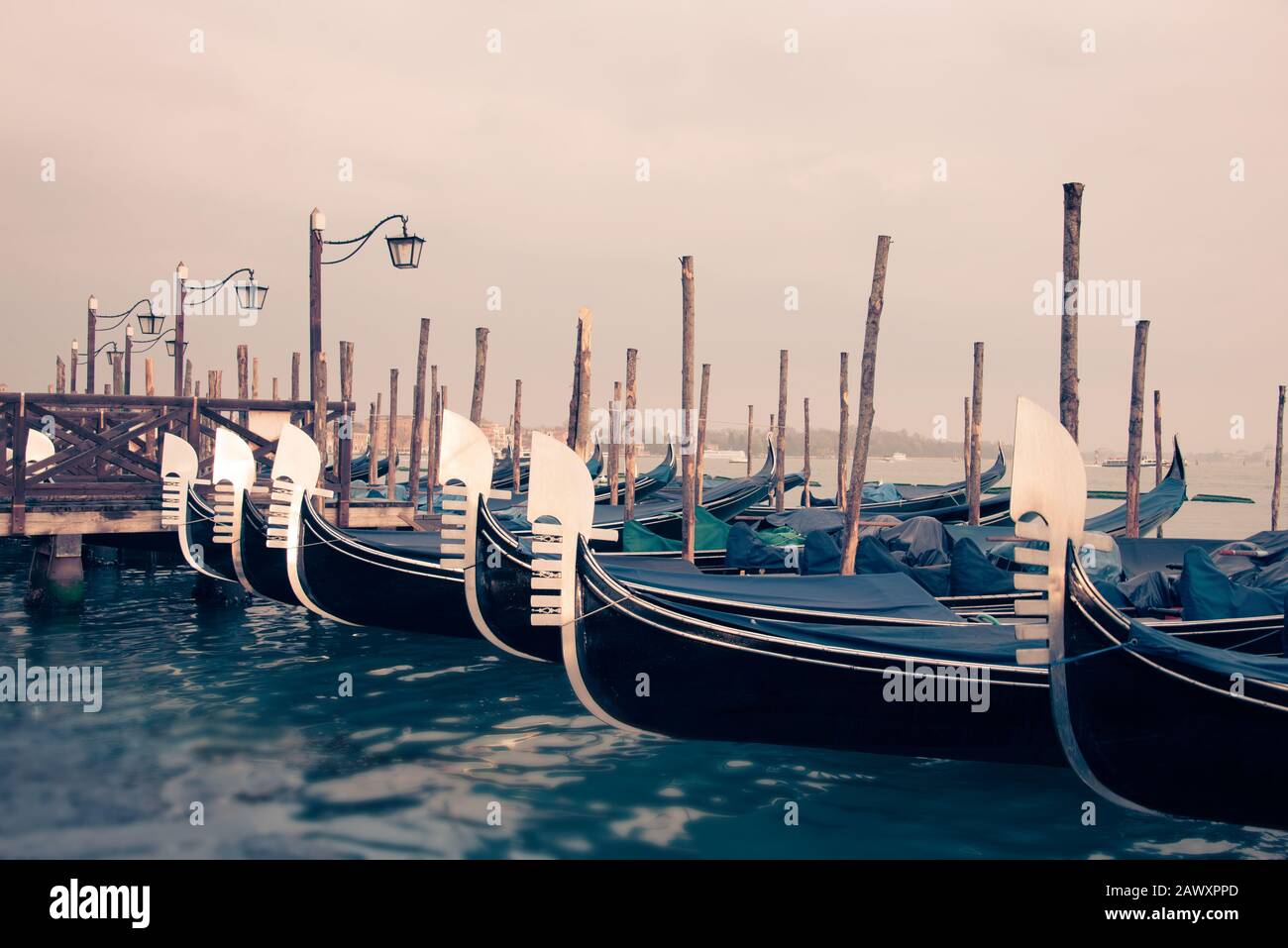 Gondolas and wooden pier in winter in Venice, Italy Stock Photo