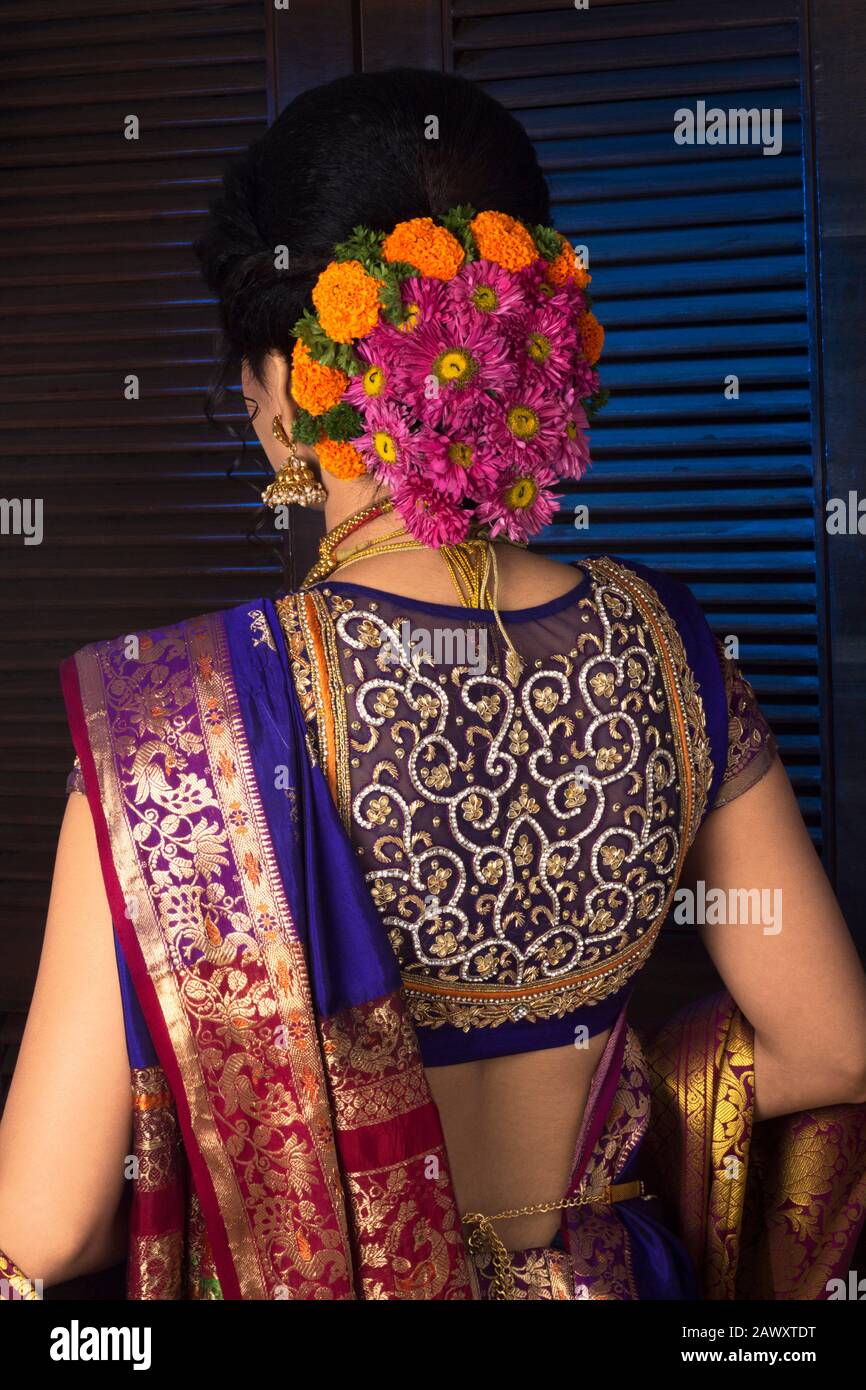 Indian Model wearing traditional Maharashtrian silk saree, back view with  flower braid on hair Stock Photo - Alamy