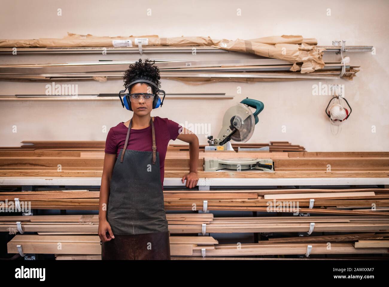 Female artsian standing in her frame making workshop Stock Photo