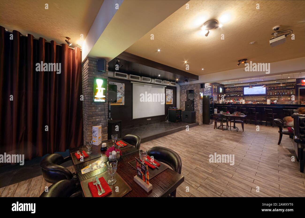 MOSCOW - SEPTEMBER 2014: The interior of a large beer restaurant 'Yan Primus'. Scene with a screen for a projector in the restaurant hall Stock Photo