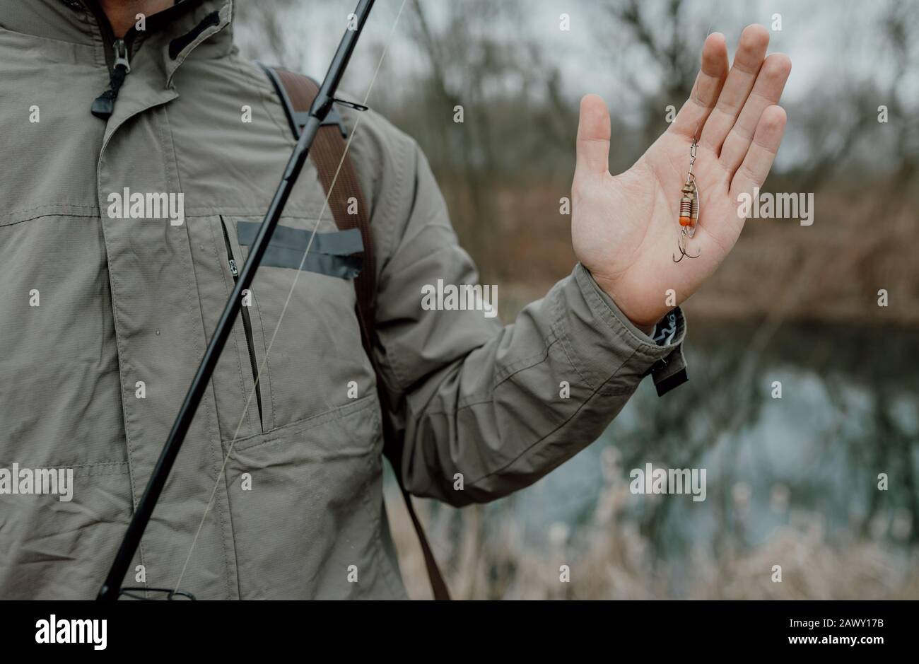 Man holding fishing rod and bait in his hands, close up Stock Photo Alamy
