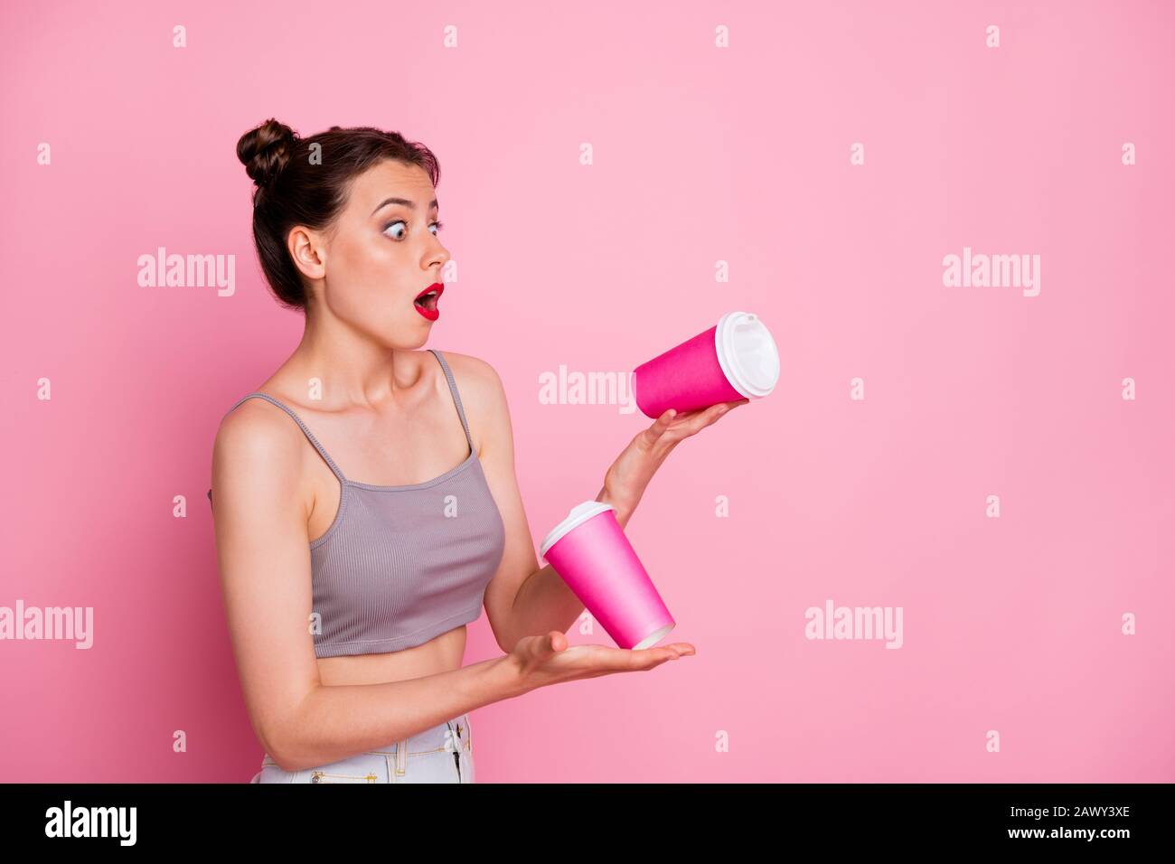 Portrait of astonished girl hold take-away cup falling down she impressed scream omg feel frustrated emotion wear casual style clothing isolated over Stock Photo