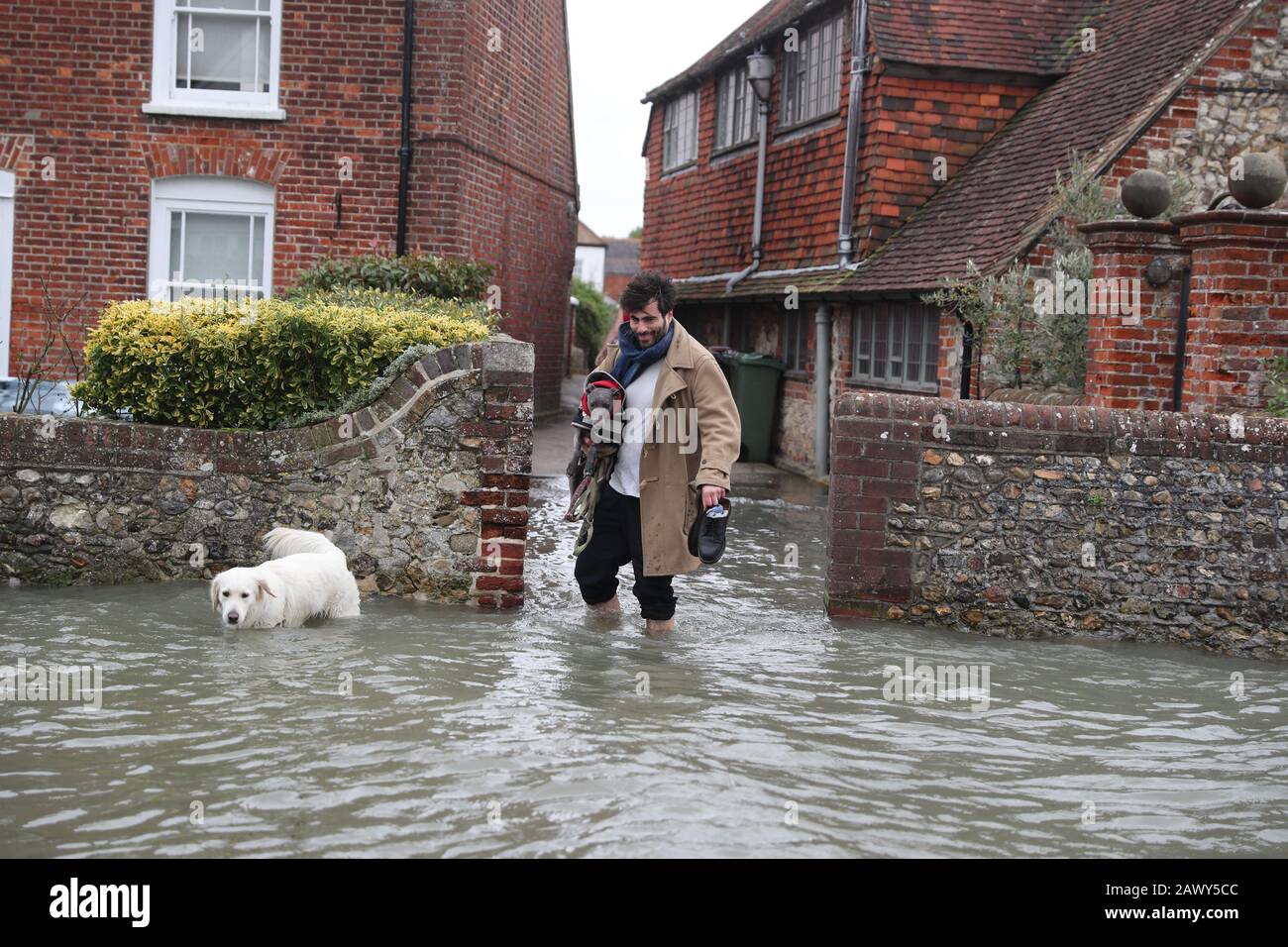 Flooding in Bosham, Sussex caused by the high tide, the Met Office have said that 'a spell of very strong winds,' with gusts of 60-70mph, is expected across southern England on Monday, bringing likely delays to road, rail, air and ferry transport. Stock Photo