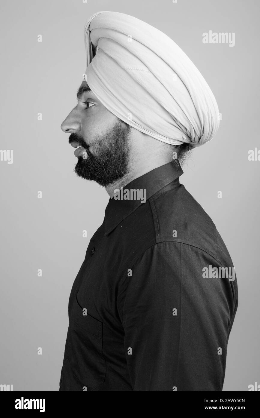 Portrait of young bearded Indian Sikh businessman with turban Stock Photo