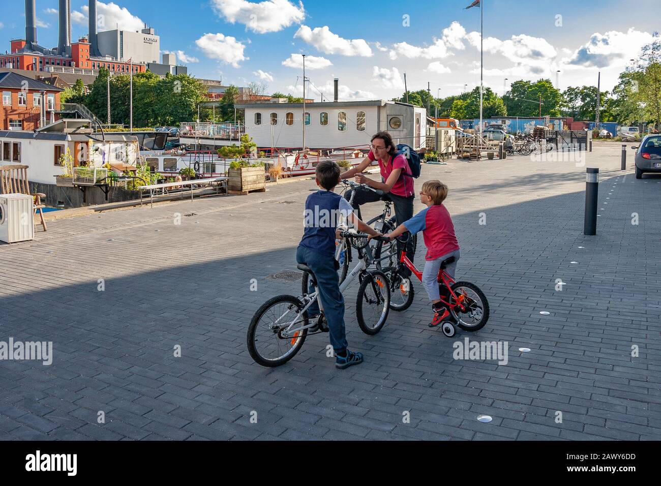 mother and children on bicycles Stock Photo