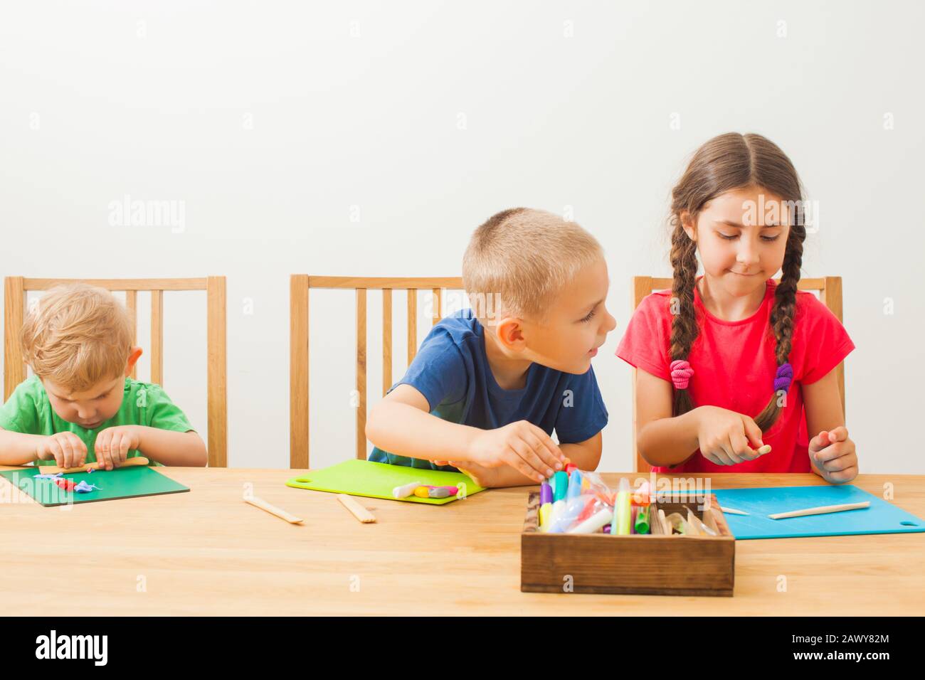 Cute little children modeling from playdough at home Stock Photo