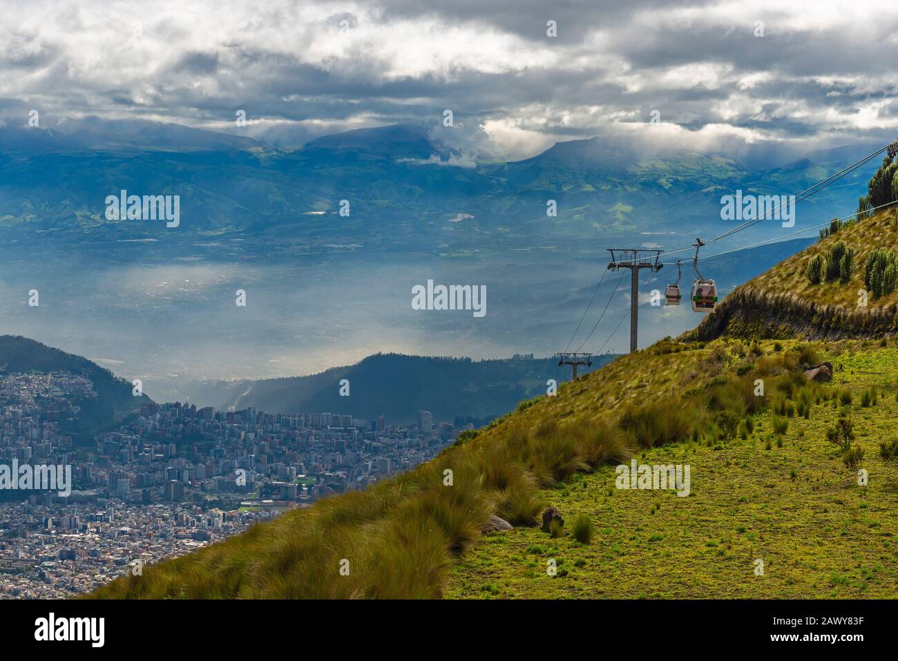 Cityscape of Quito seen from the Pichincha volcano with the cable car of the city called Teleferico, Andes mountain range, Ecuador. Stock Photo
