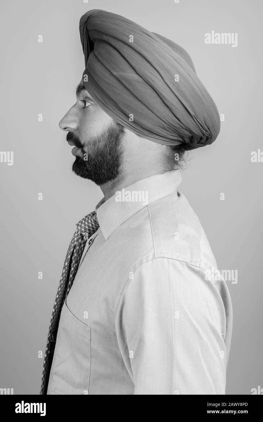 Portrait of young bearded Indian Sikh businessman with turban Stock Photo