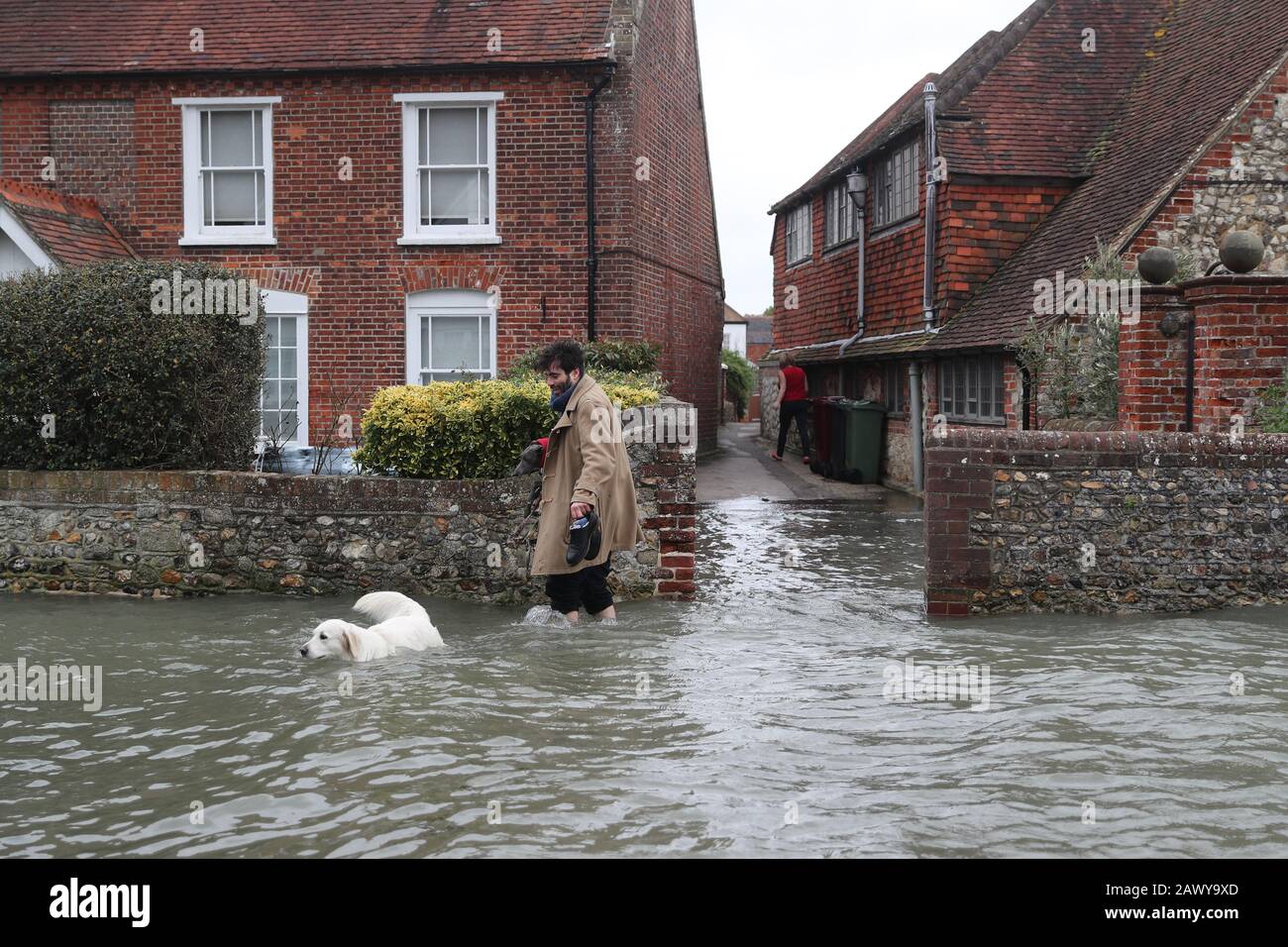 Flooding in Bosham, Sussex caused by the high tide, the Met Office have said that 'a spell of very strong winds,' with gusts of 60-70mph, is expected across southern England on Monday, bringing likely delays to road, rail, air and ferry transport. Stock Photo