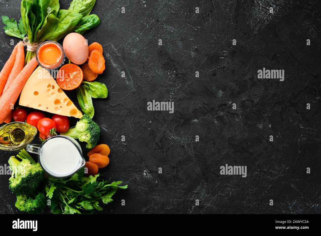 Healthy Foods Fruits And Vegetables Broccoli Carrots Milk Cheese Spinach Dried Apricots Parsley Tomatoes Top View Stock Photo Alamy