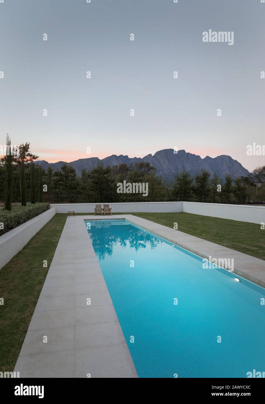 Luxury lap pool with view of mountains at dusk Stock Photo
