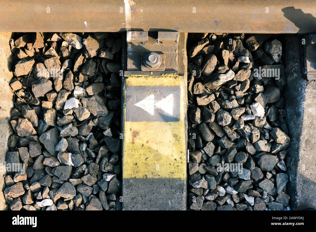 Rail fastenings on the railway. Metal parts and sleepers for the safety of train traffic Stock Photo