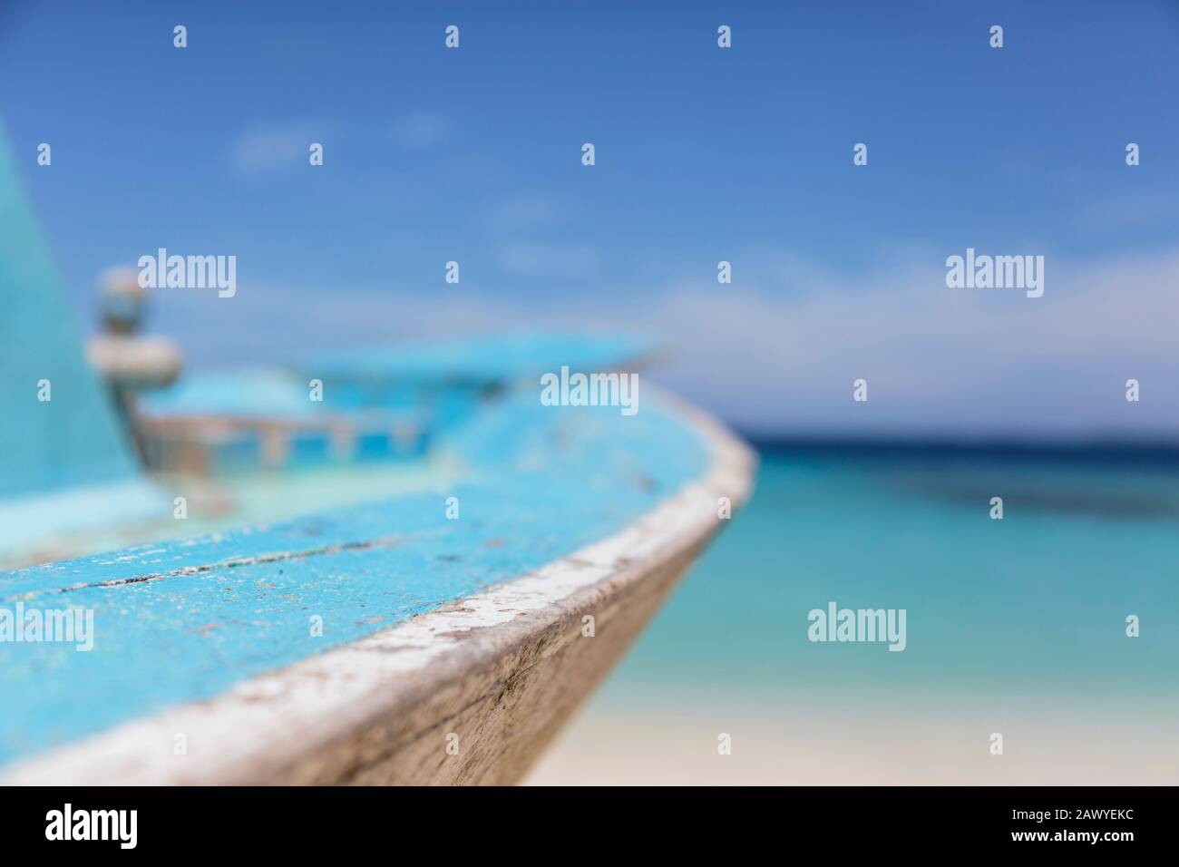 Close up turquoise blue boat on sunny beach, Maldives Stock Photo