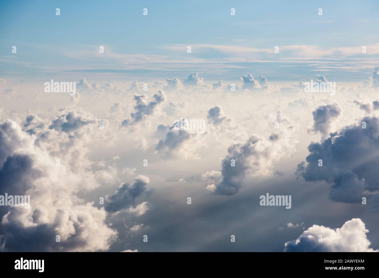 Aerial view fluffy white clouds in sunny, ethereal sky Stock Photo - Alamy