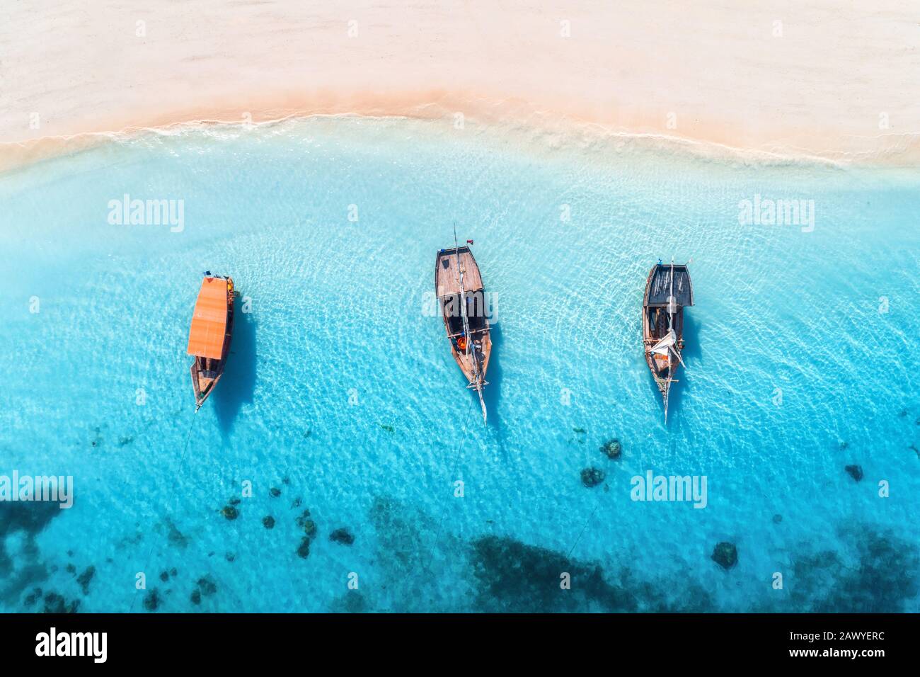 Aerial view of the fishing boats in clear blue water at sunset Stock ...