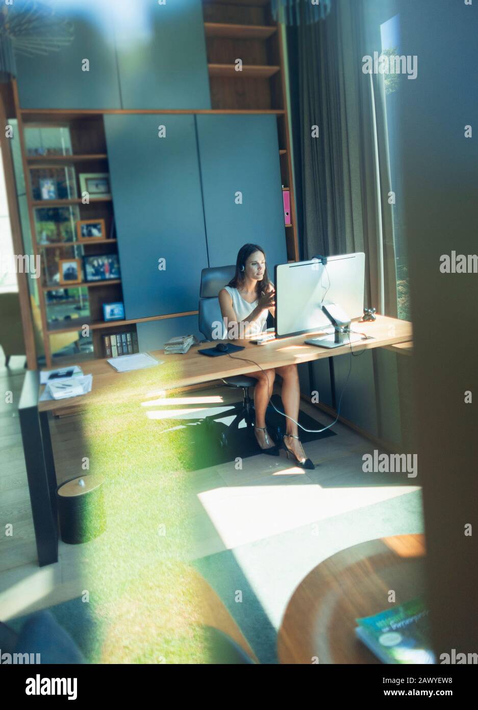Businesswoman working at computer in home office Stock Photo