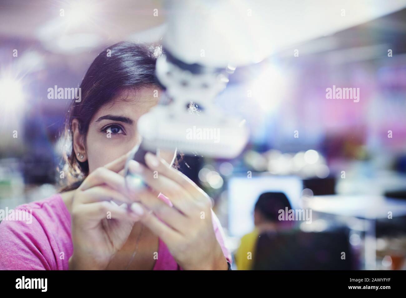 Focused female engineer repairing robotic arm Stock Photo