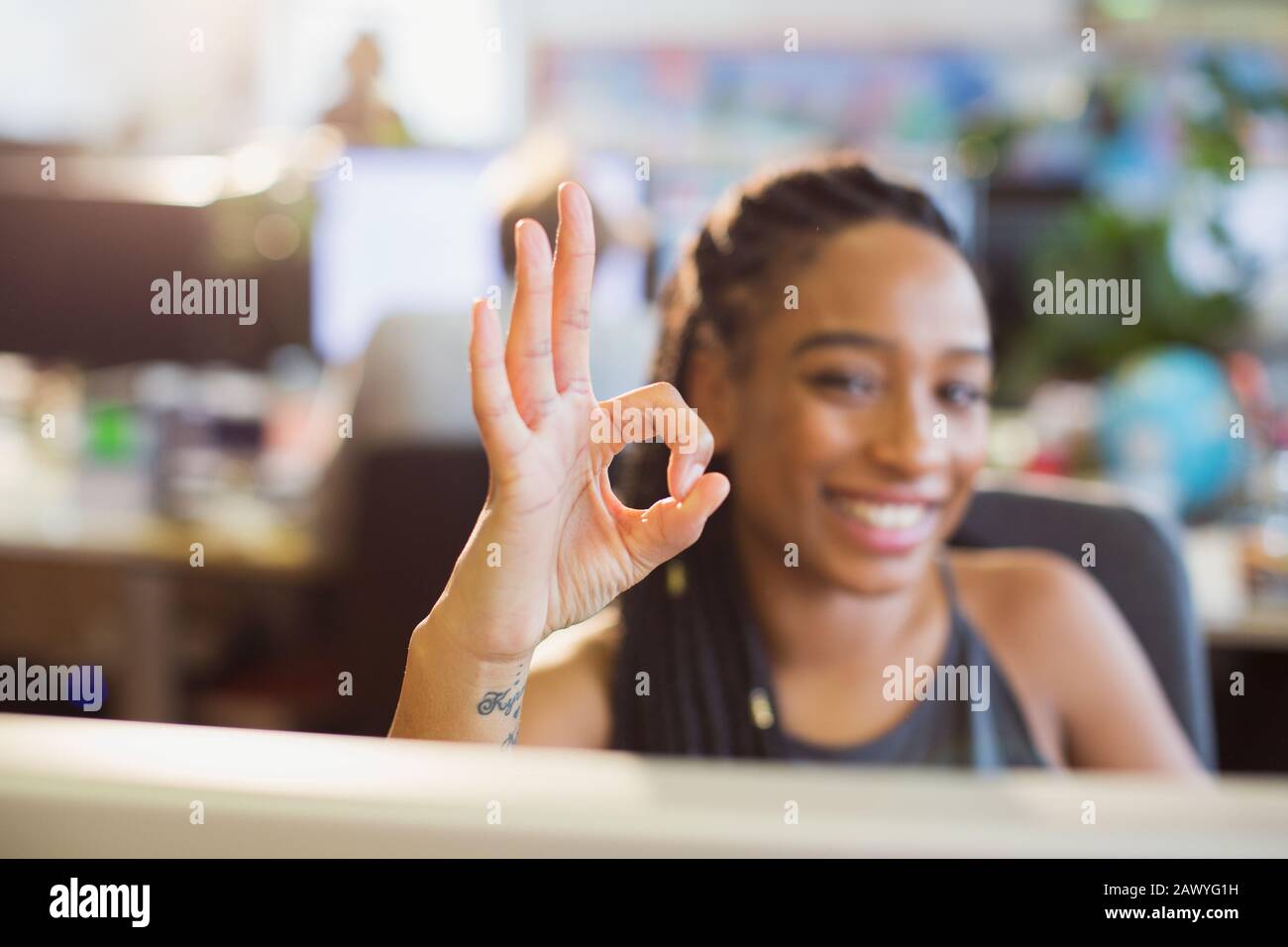 Portrait confident, ambitious businesswoman gesturing OK with hand in office Stock Photo