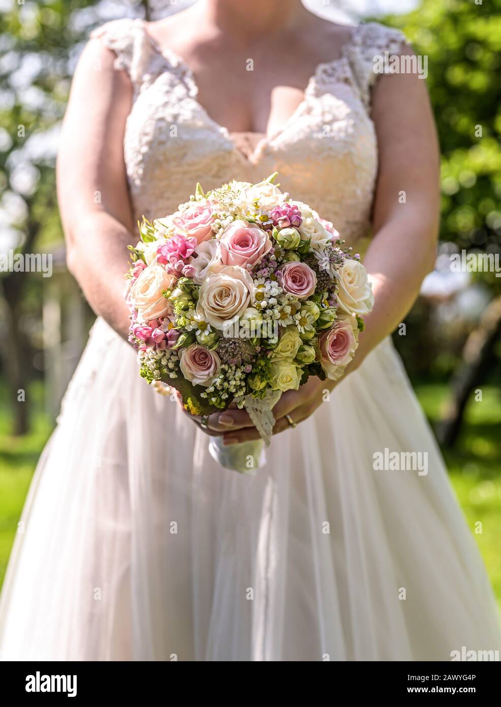 Wedding Bouquet Of Flowers Held By Bride Closeup Pink And Yellow Roses Flowers Stock Photo Alamy