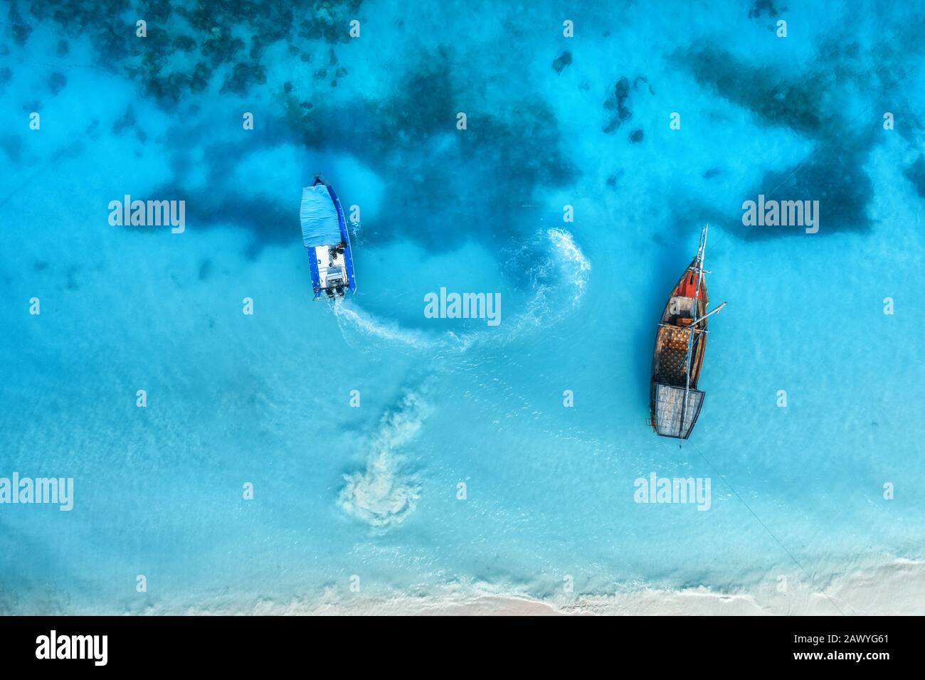 Aerial view of the fishing boats in clear blue water at sunset Stock ...