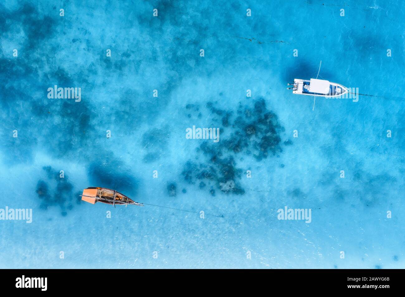 Aerial view of the white boat in the clear blue water at sunset Stock ...