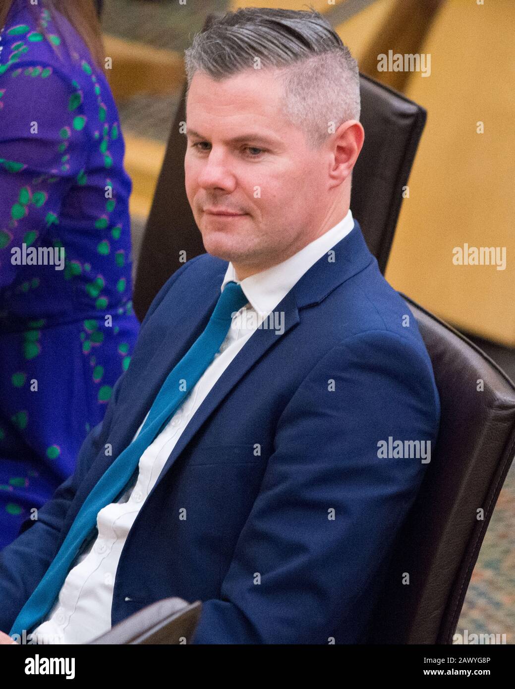 Edinburgh, UK. 5 February 2020. Pictured: Derek Mackay MSP - Cabinet Minister for Finance, seen in the chamber of the Scottish Parliament at the time he got the text on his mobile phone with thee allegations being put to him.  He within the hour he had a meeting with the First Minister, Nicola Sturgeon where he entered his resignation immediately.  He was then suspended pending an investigation. Stock Photo