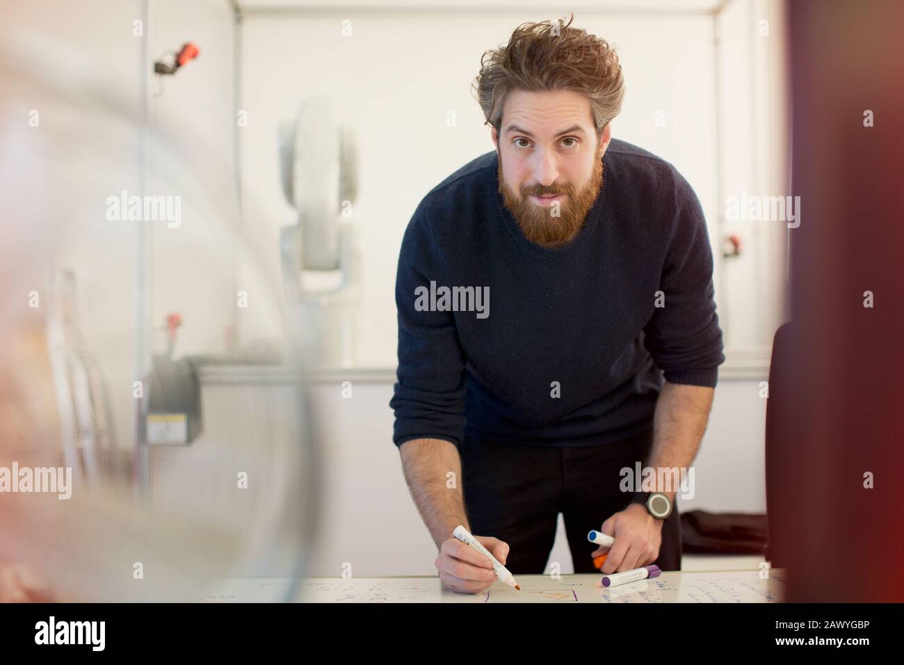 Portrait confident male engineer planning at whiteboard in office Stock Photo