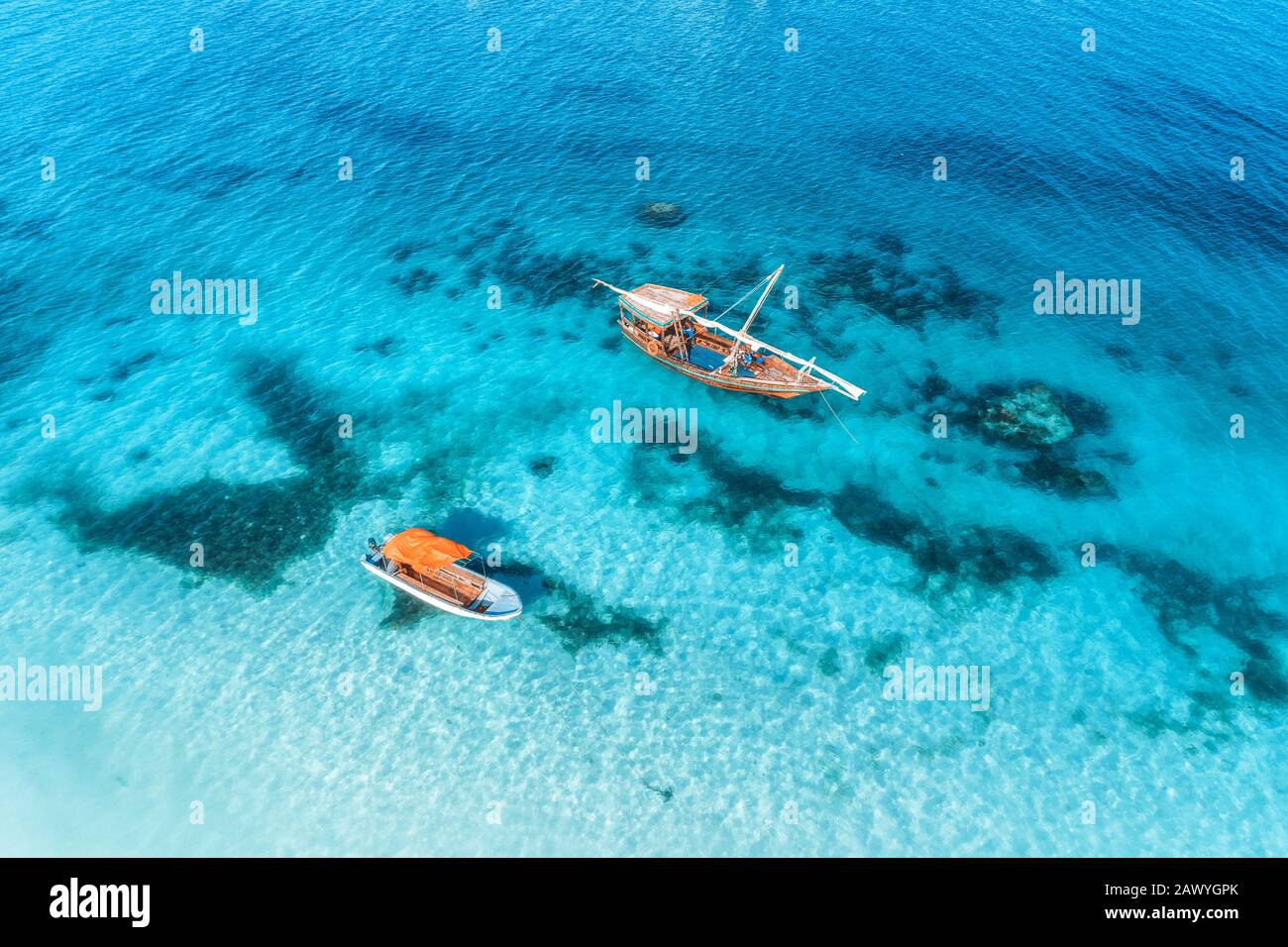 Aerial view of the fishing boats in clear blue sea at sunset Stock ...