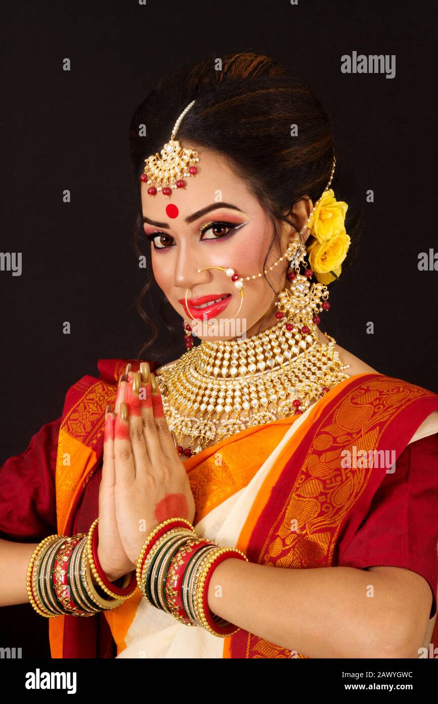 Portrait of an young and beautiful Indian Bengali brunette woman in red ...