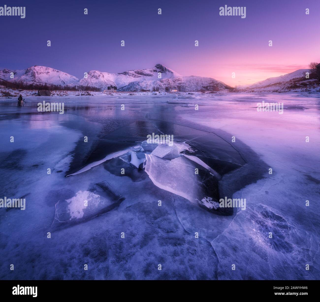Snowy mountains, sea with frosty coast and purple sky Stock Photo