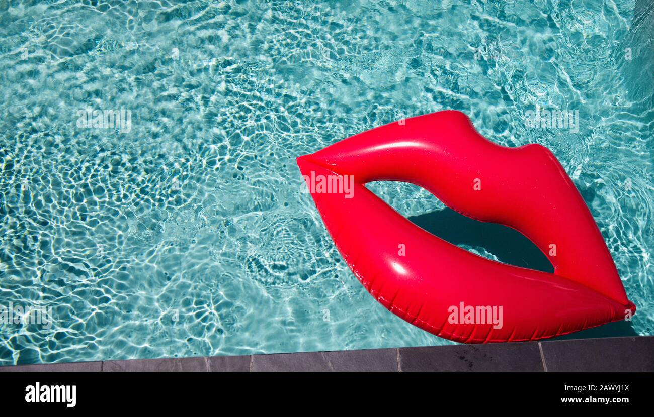 Inflatable lips floating in sunny summer swimming pool Stock Photo Alamy
