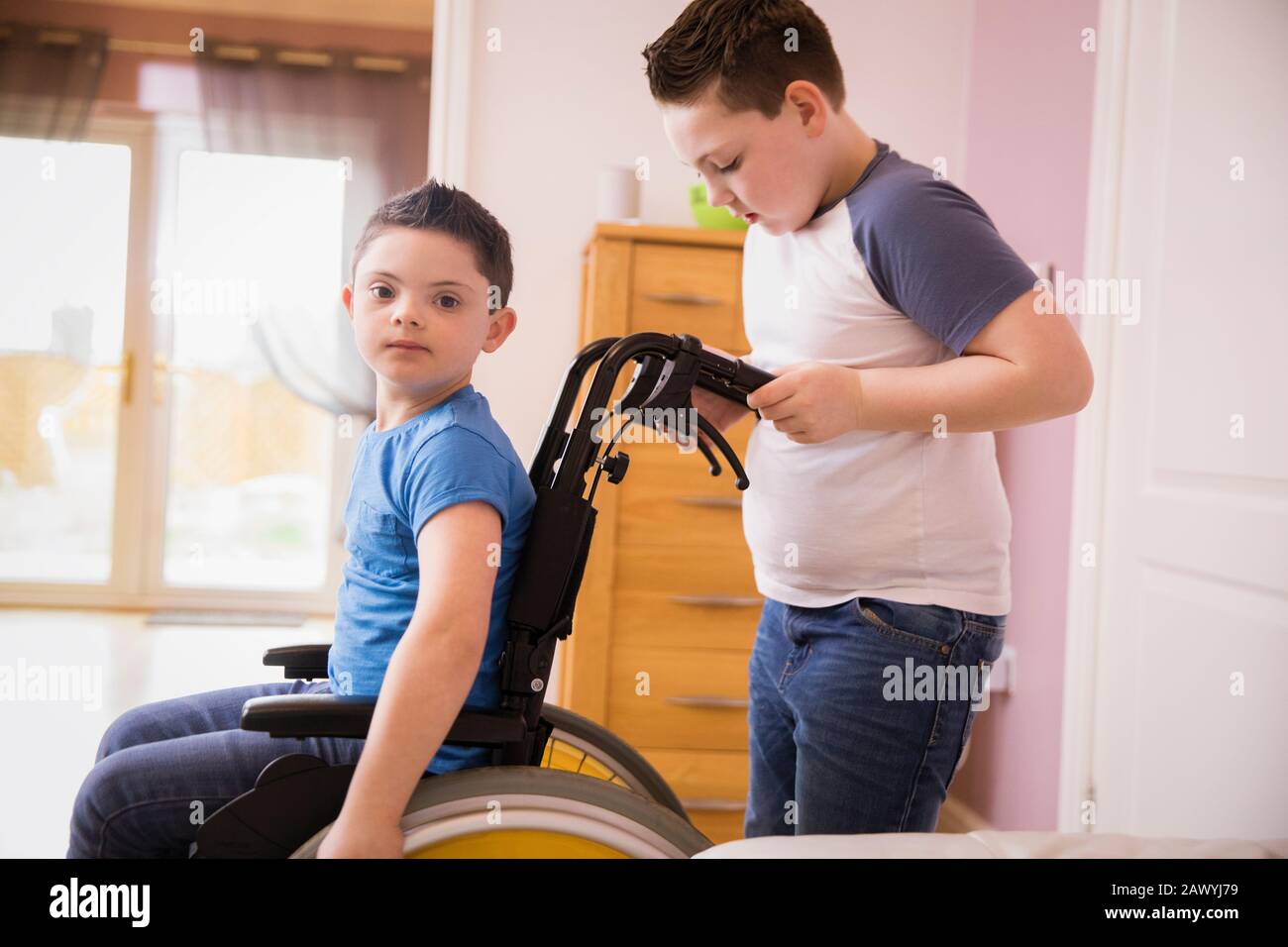 Portrait boy with Down Syndrome in wheelchair Stock Photo