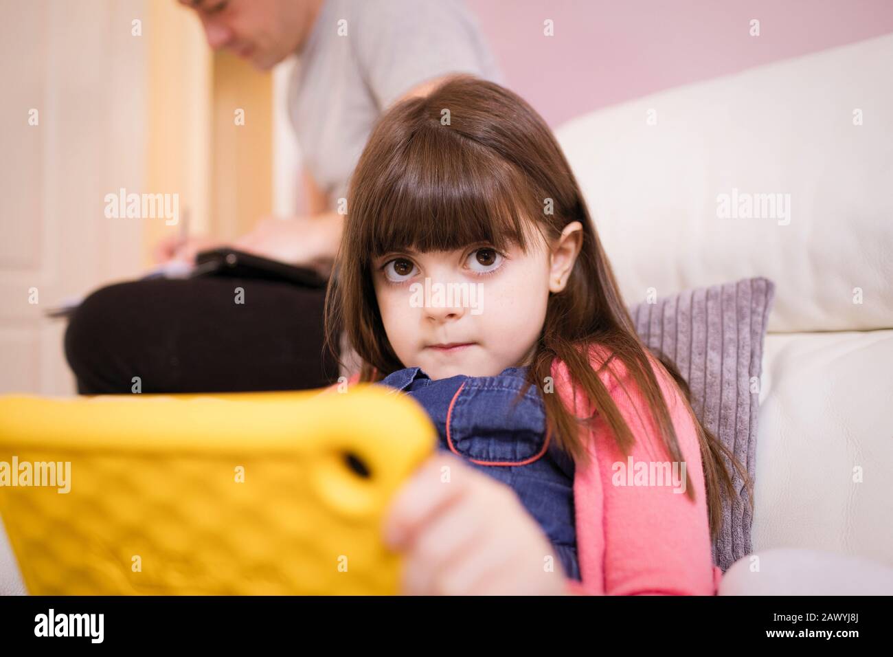 Portrait innocent girl using digital tablet on sofa Stock Photo