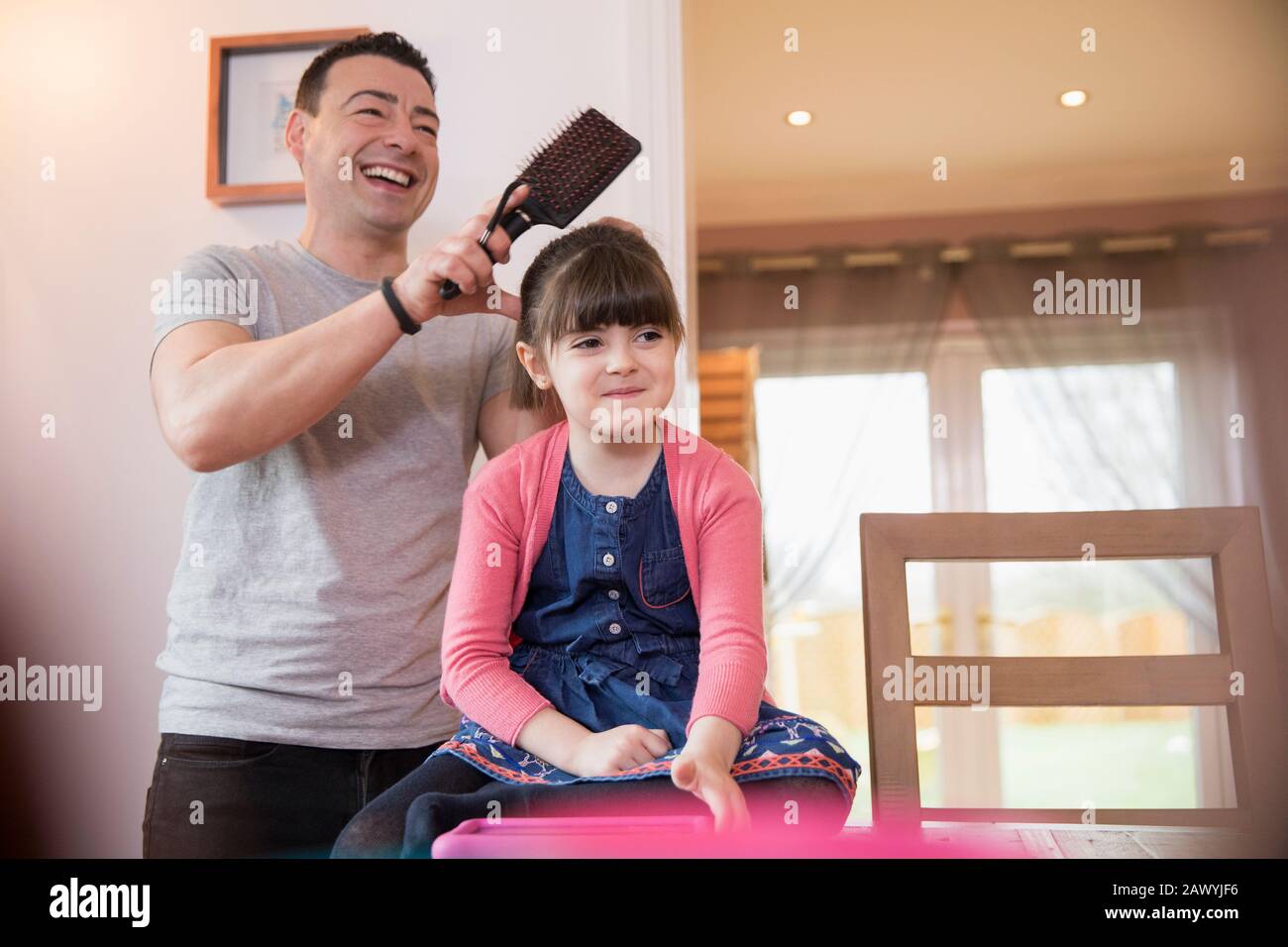 Father brushing daughter's hair Stock Photo