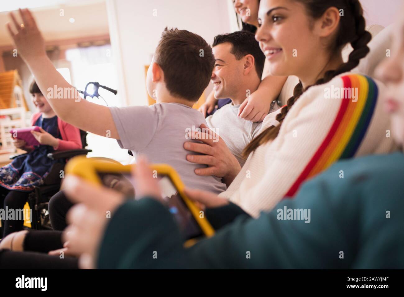 Family watching TV on living room sofa Stock Photo