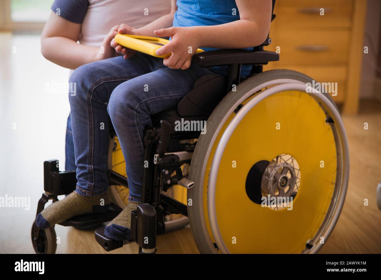 Boy in wheelchair using digital tablet Stock Photo
