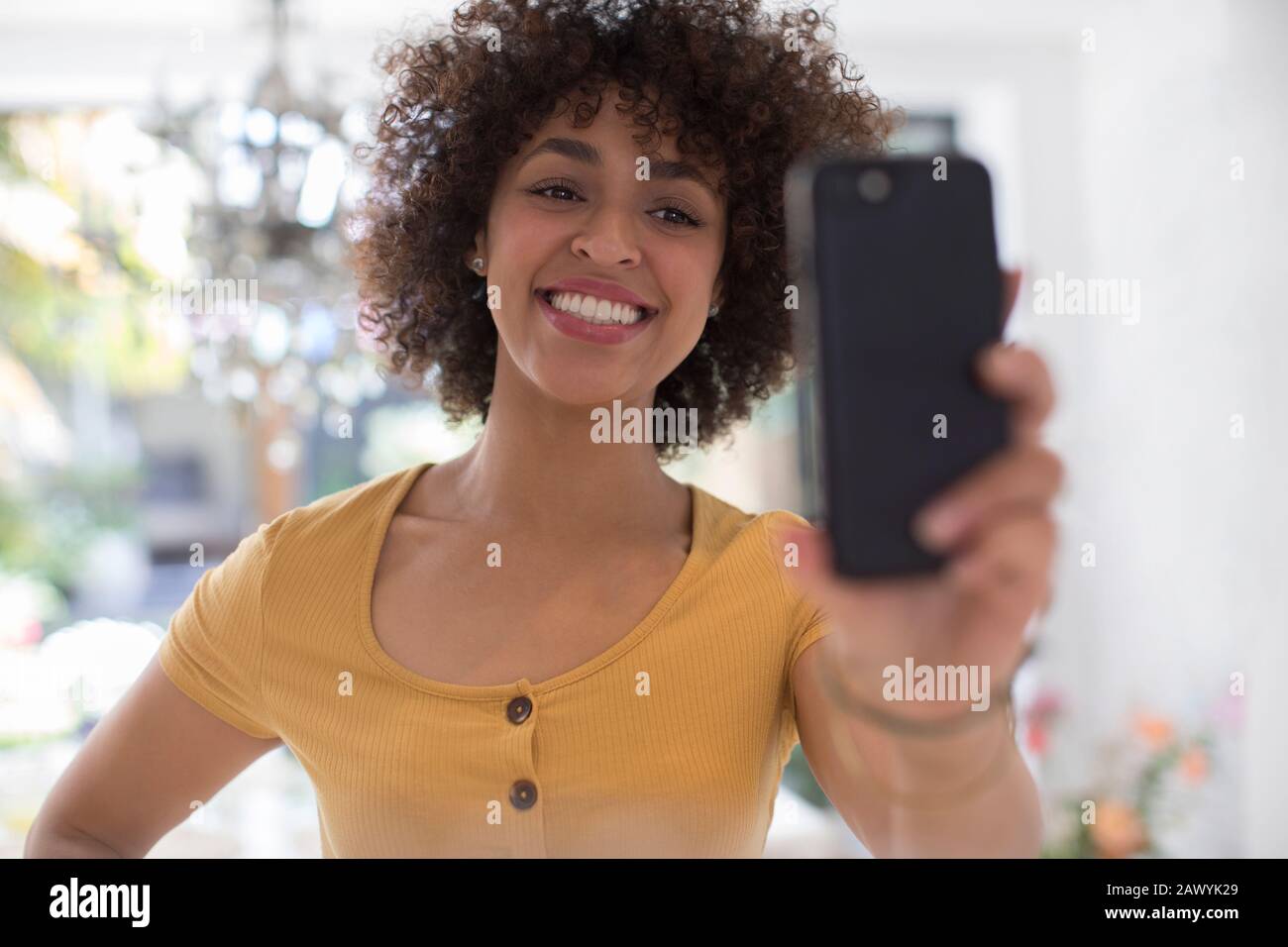 Happy young woman taking selfie with camera phone Stock Photo