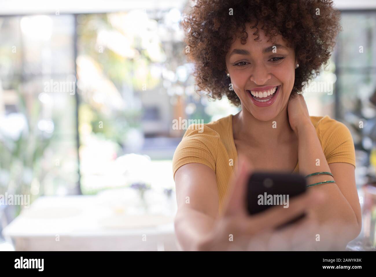 Playful happy young woman taking selfie with camera phone Stock Photo