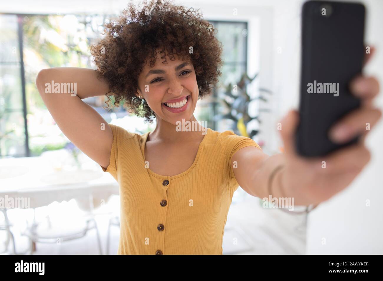 Happy confident young woman taking selfie with smart phone Stock Photo