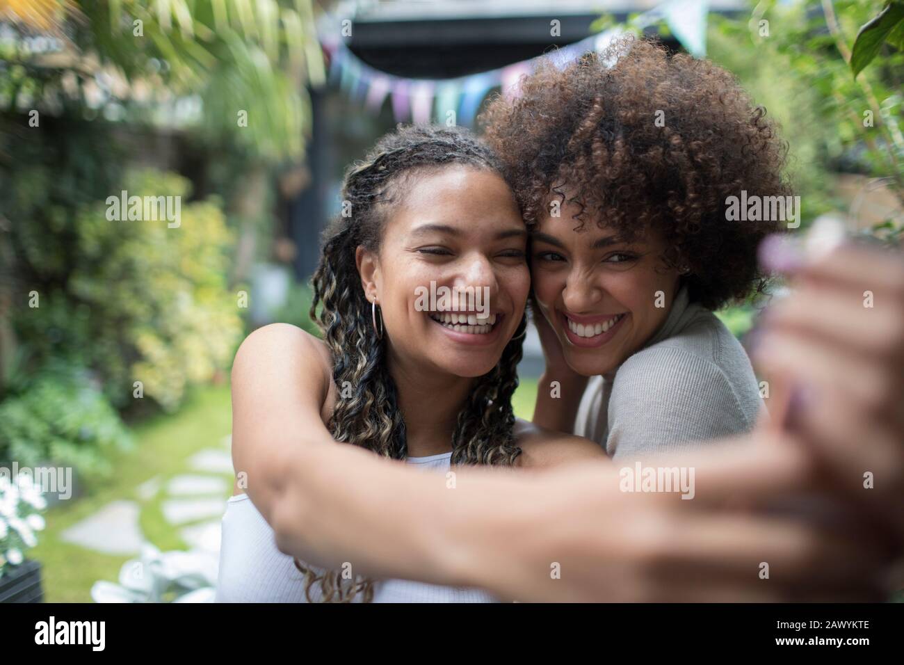 Happy young women friends taking selfie with camera phone Stock Photo