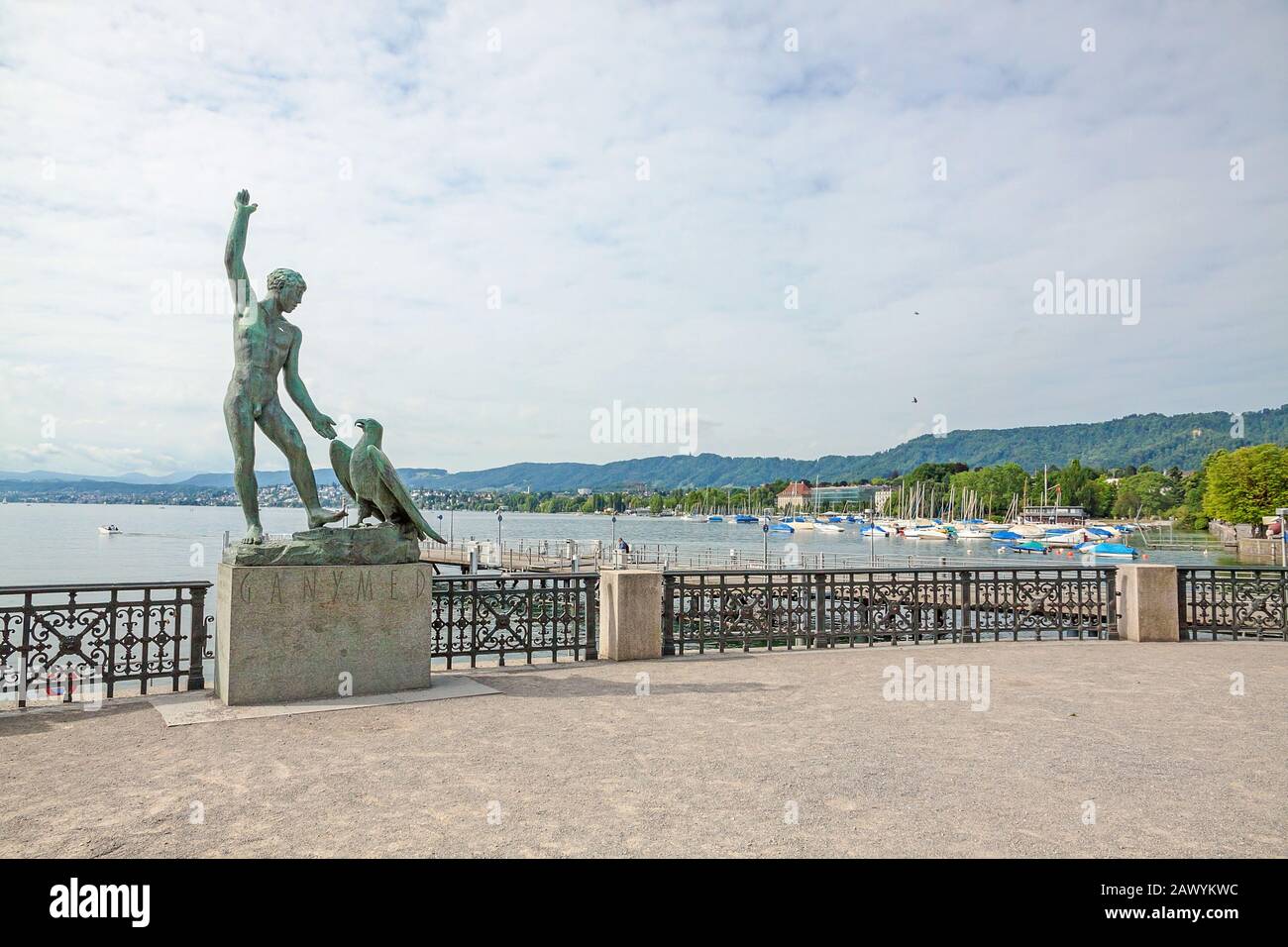 Zurich, Switzerland - June 10, 2017: Ganymed Statue (statue of a man and a eagle) in Zurich, Switzerland - Lake Zurich panorama in the background Stock Photo