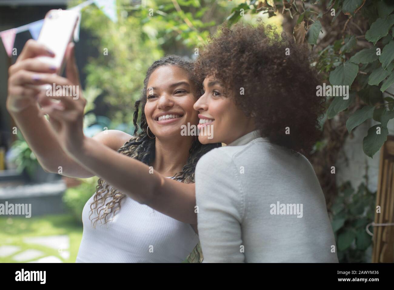 Beautiful young women friends taking selfie with camera phone Stock Photo