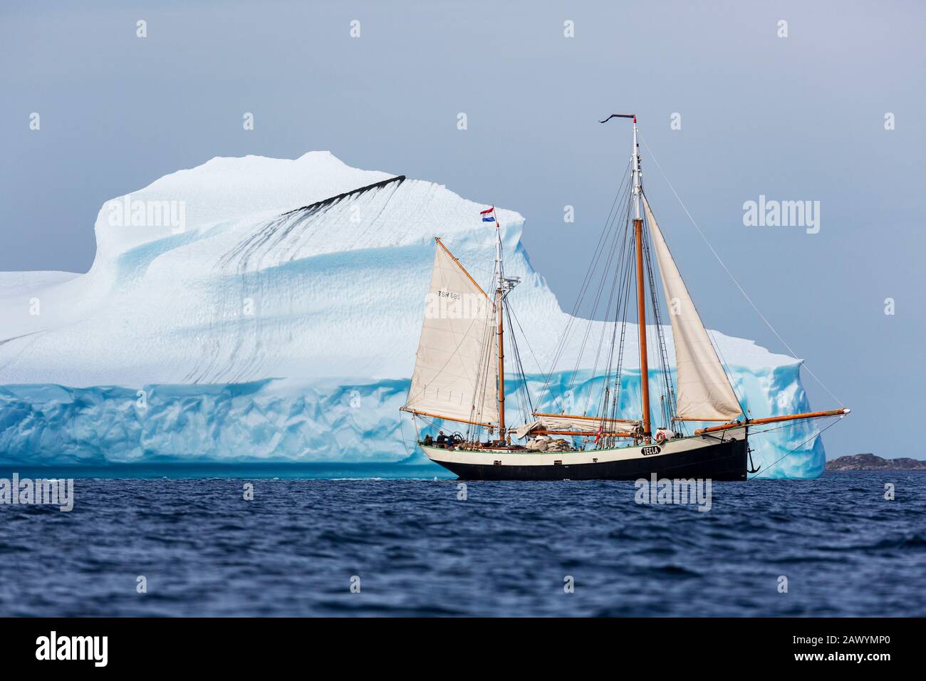 Ship sailing along iceberg formation Atlantic Ocean Greenland Stock Photo