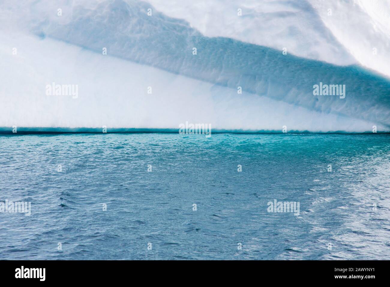 Turquoise blue ocean water below iceberg Greenland Stock Photo